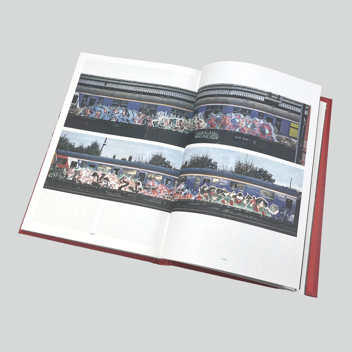 Catalogue of Unsolved Crimes, open spread with photographs of painted trains