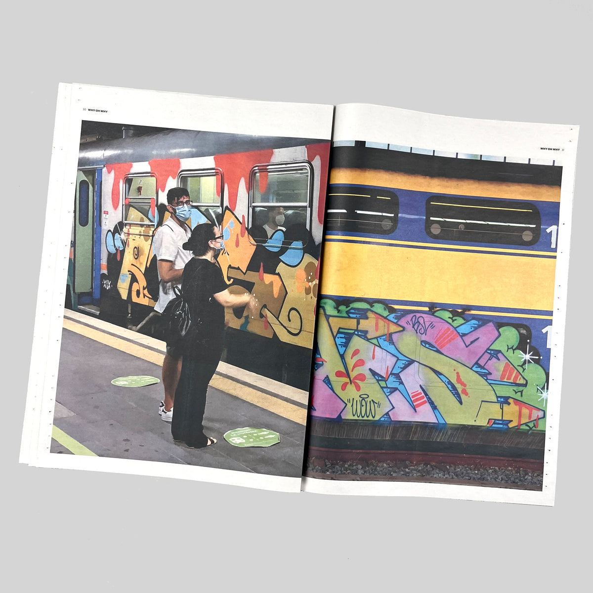 Why Oh Why, open spread with two people standing next to a painted train