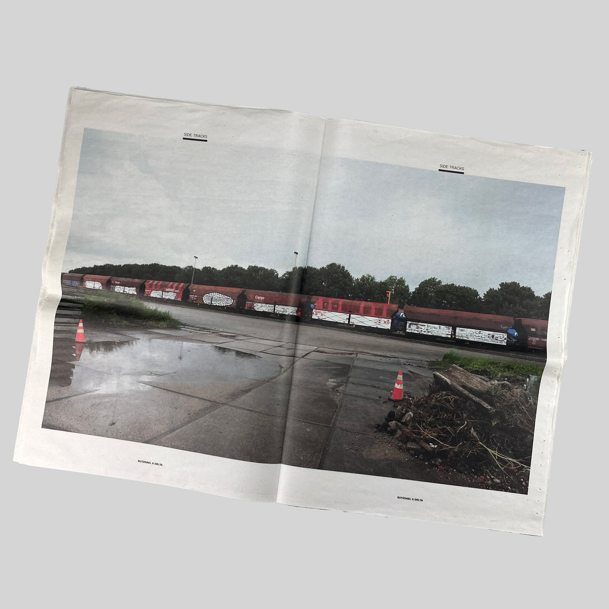 Side Tracks, open spread with a photograph of a freight train in an industrial area