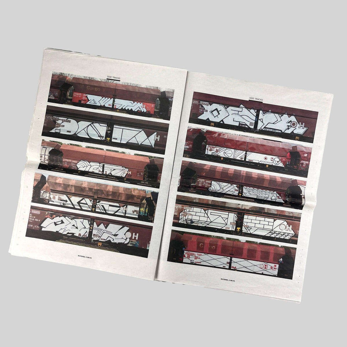 Side Tracks, open spread with rows of photographs of painted freight wagons