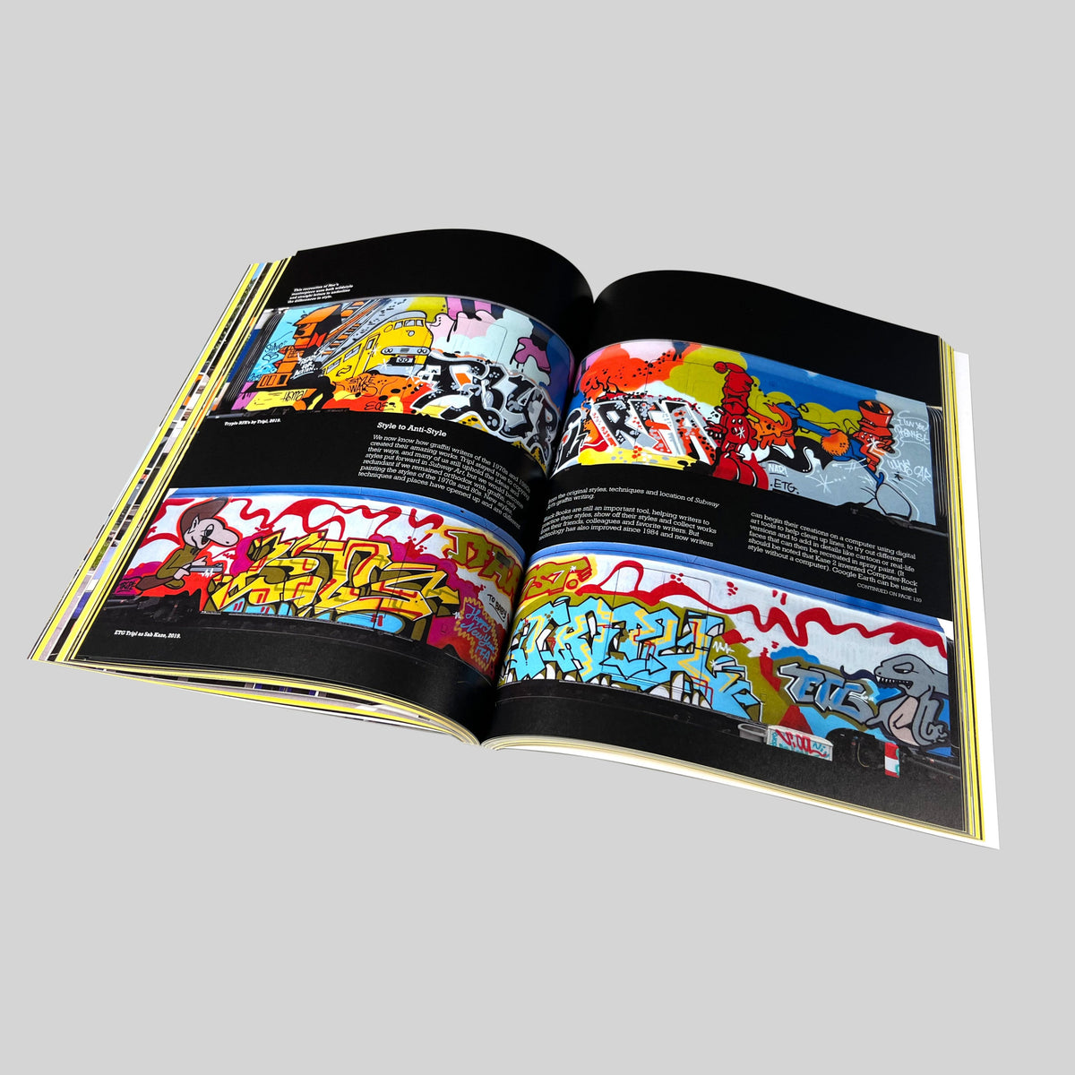 Repainting Subway Art, open spread with photographs of painted trains on black pages