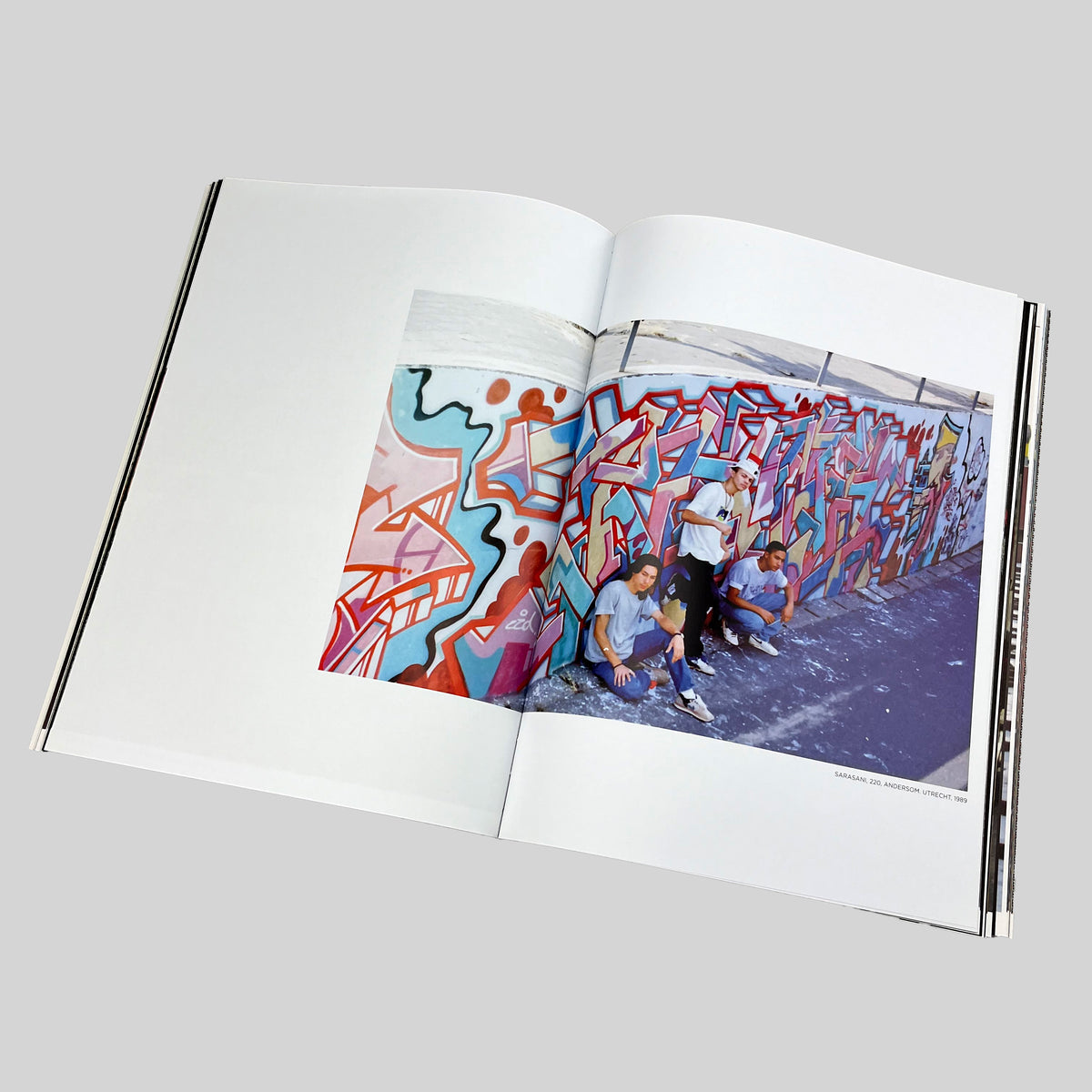 Shave's Cut, open spread with a photograph of people in front of a painted wall
