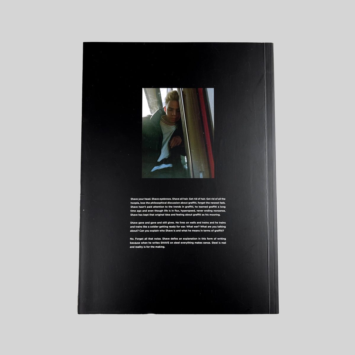 Shave's Cut, black back cover with a photograph and text