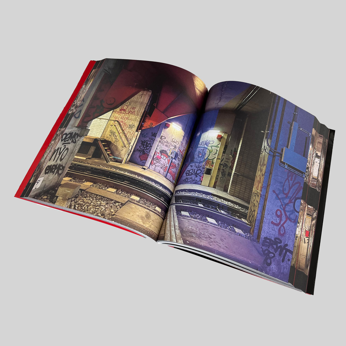 Tunnel Vision, open spread with photographs of graffiti on walls and stairs beside the metro tracks