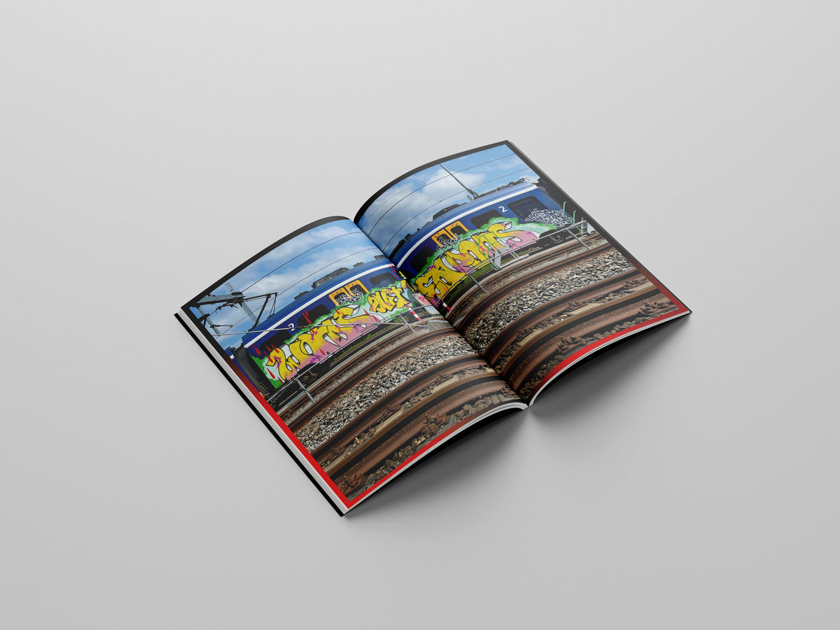 Writing Our World, open spread with a photograph of a painted train on the tracks