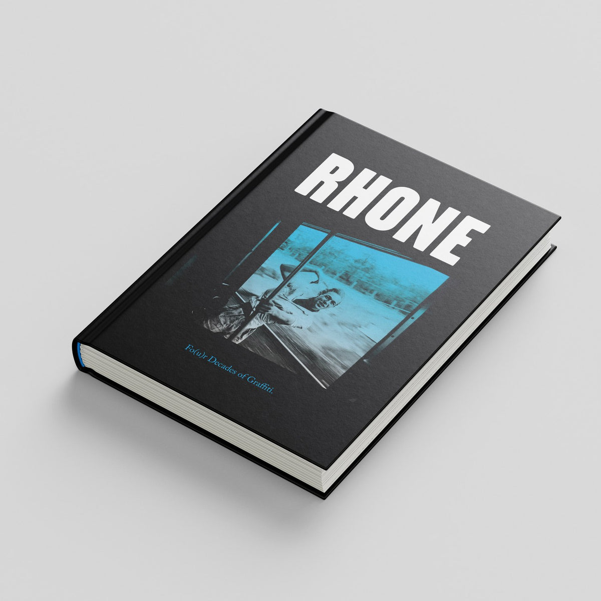 Rhone, mock-up of the black hardcover with the title above a blue-toned photograph of Rhone at a train window
